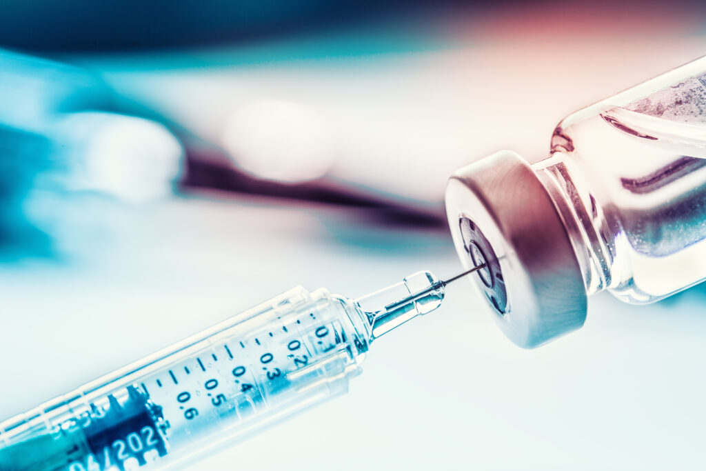 Close-up of a medical syringe filled with a vaccine.